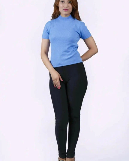 Italian Cashmere Short Sleeve Mock Neck with flattering turtle neck in smart cable pattern worn by woman in blue top and black pants