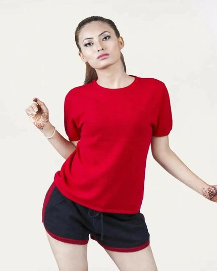 Woman in red shirt and black shorts modeling Italian Cashmere Turtle Neck T-Shirt with flattering turtle neck design