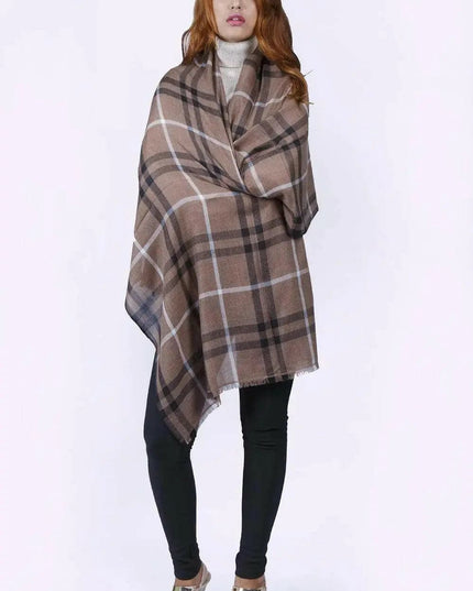 Woman in KCI 182 brown and black plaid poncho with raw trim