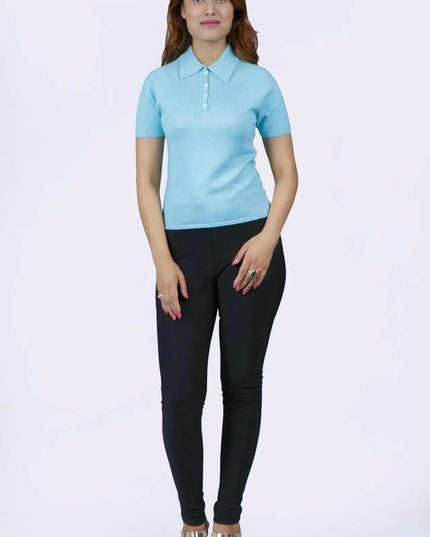 Woman in blue shirt and black pants, teal polo collar, KCI 232