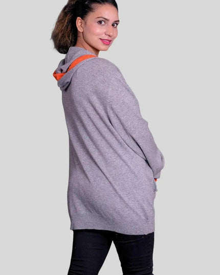 Woman wearing a grey cashmere hooded sweater with orange trim - KCI 293