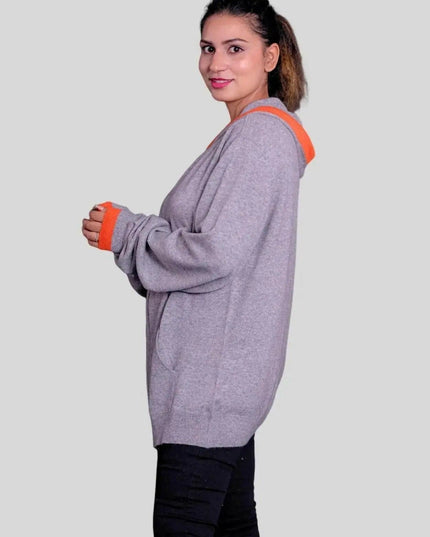 Woman in KCI 293 cashmere hooded sweater with orange trims