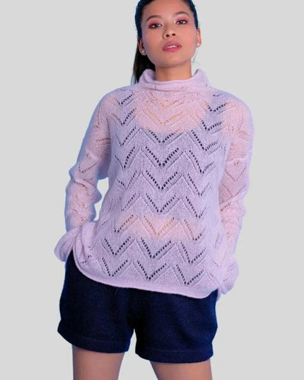 Woman wearing luxurious cashmere silk pointelle pullover in pink