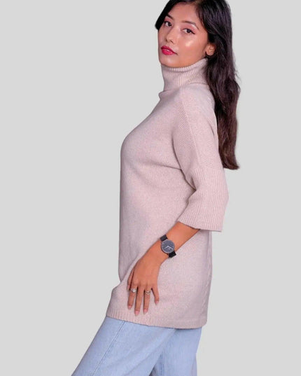 Luxurious cashmere turtleneck pullover modeled by woman in pink sweater