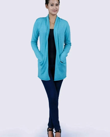 Luxurious Italian Cashmere Open Pocket Garment featuring a woman in a blue cardigan sweater and black top