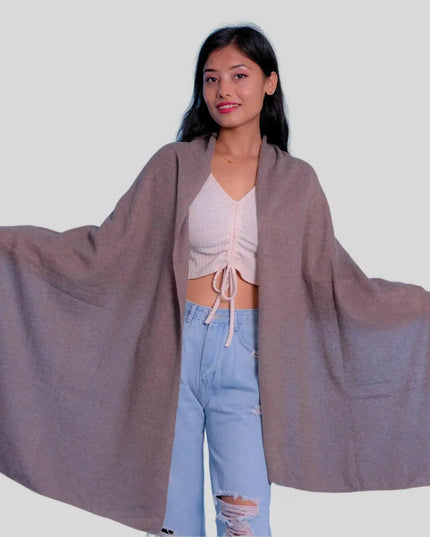 Woman in grey cape, white top, and blue jeans wearing Luxurious Italian Cashmere Scarf for winter wardrobe