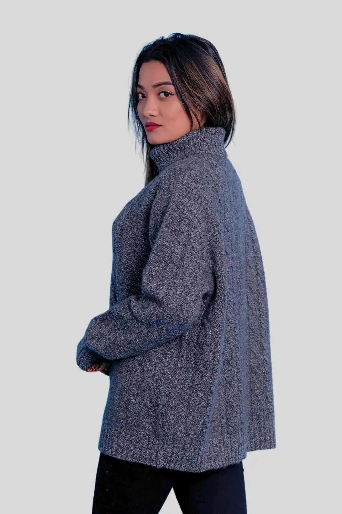 Luxuriously soft cashmere turtle neck sweater on woman in grey sweater and black pants