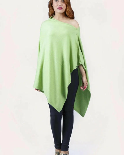 Woman wearing a green cashmere poncho from KCI 246 collection