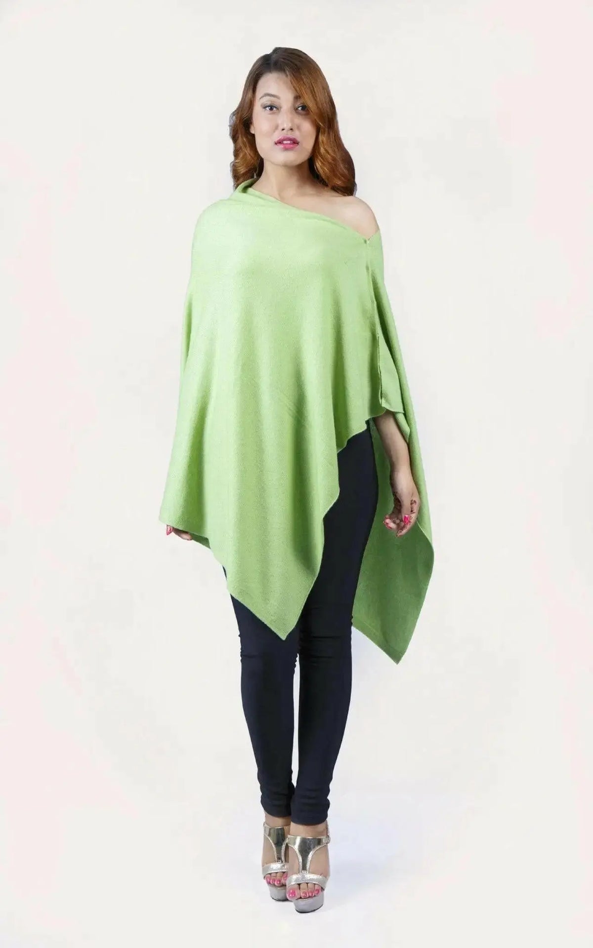 Woman wearing a green cashmere poncho from KCI 246 collection