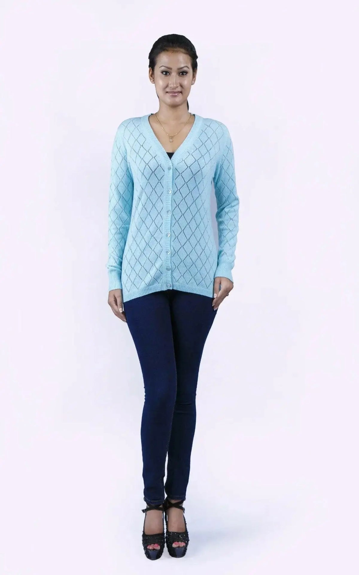 Woman in blue sweater and jeans wearing Women’s Diamond Pointelle Cashmere Cardigan with V-neck design