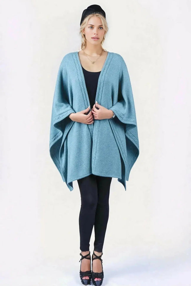 Woman wearing blue desert knit wrap ’KCI 142’ in front of white background