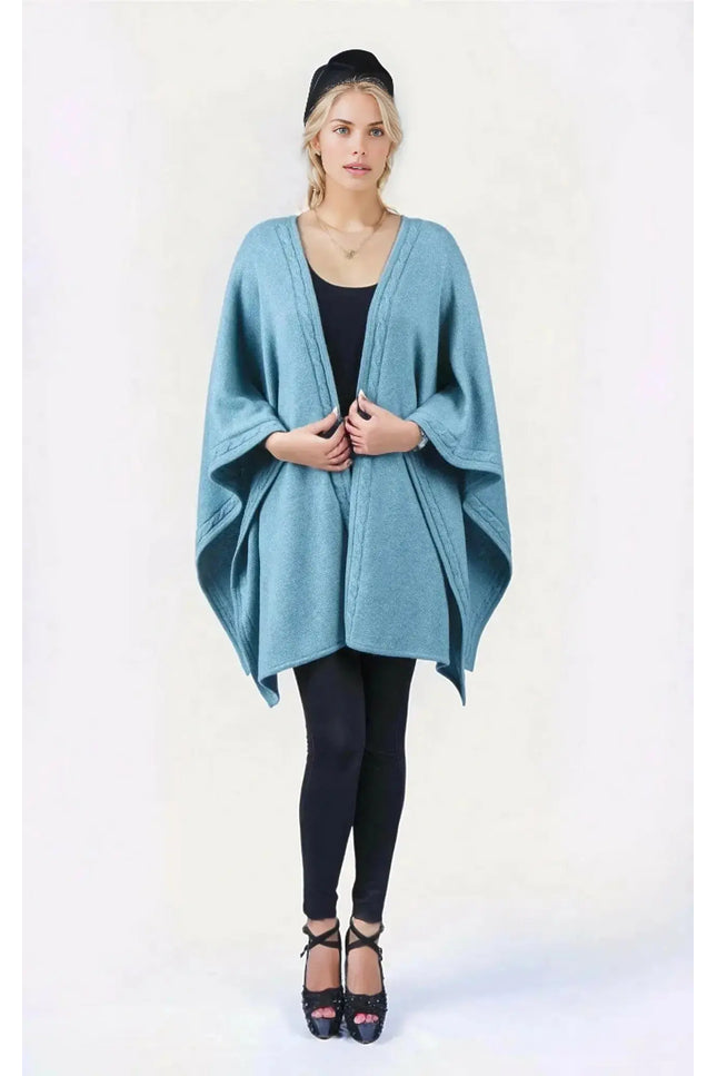 Woman wearing blue desert knit wrap ’KCI 142’ in front of white background