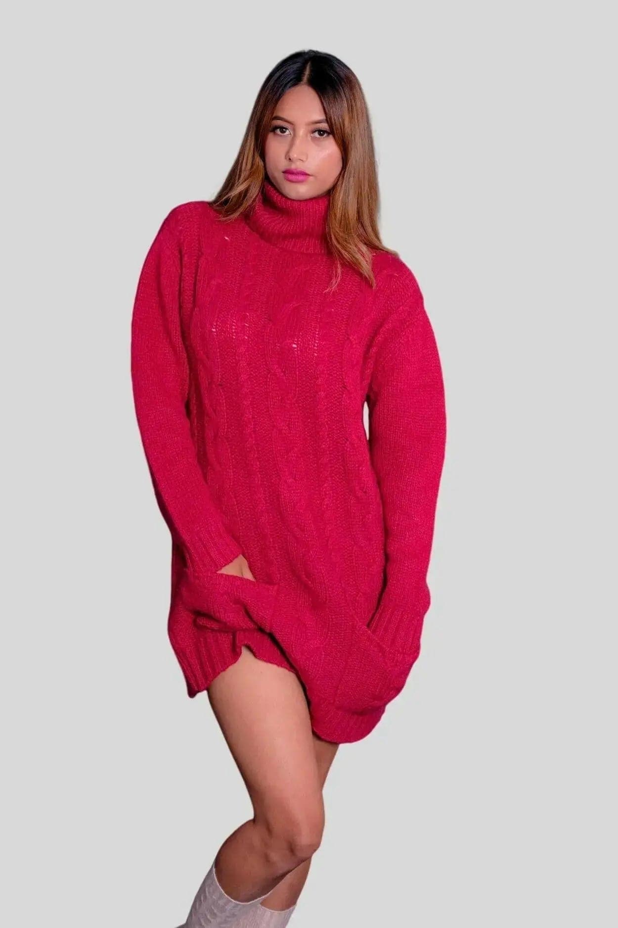 Woman in red sweater and grey boots wearing Cashmere Cable Dress with turtle neck