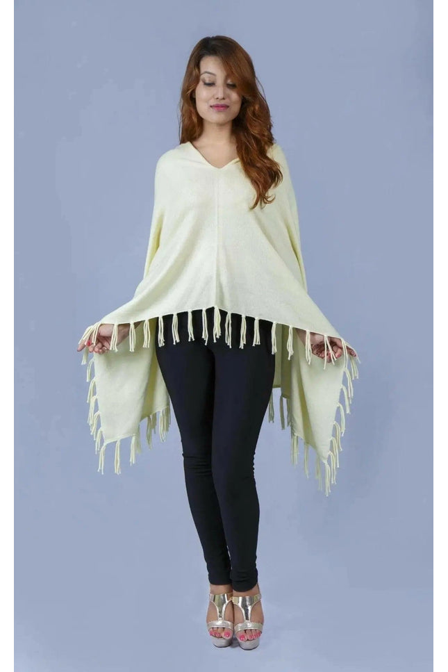 Woman wearing a yellow cashmere poncho with fringes - Kanchan Cashmere || KCI 249