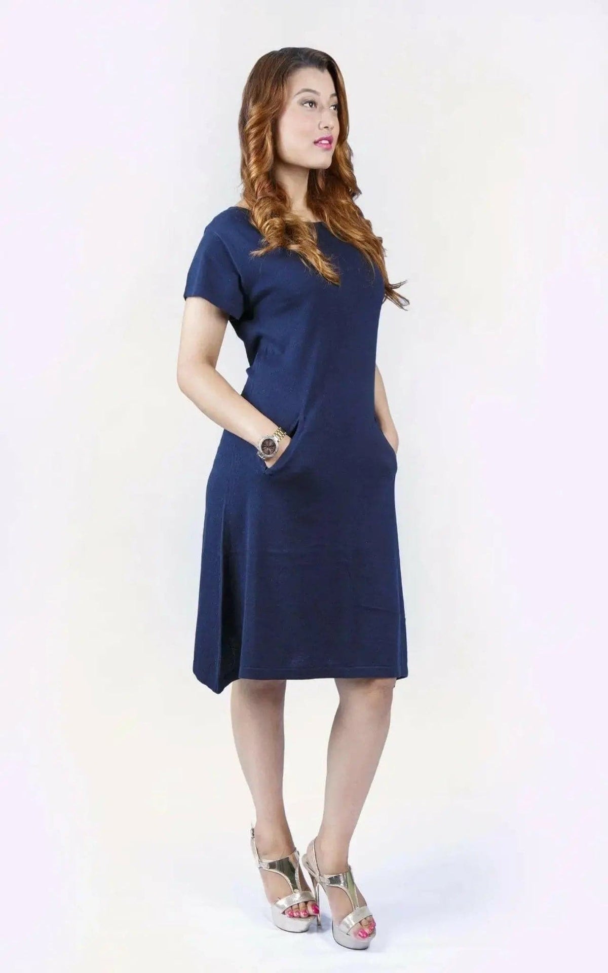 Woman in blue crew neck cashmere dress on white background