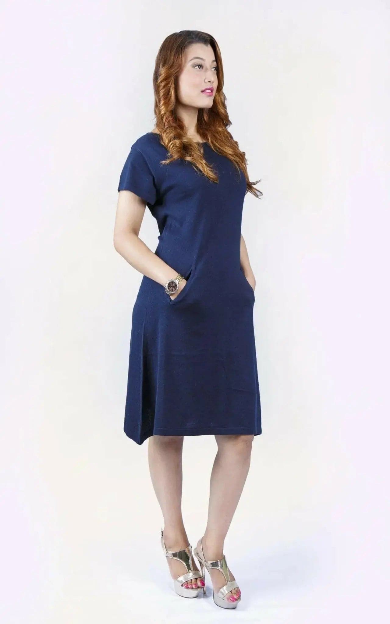 Woman in blue crew neck cashmere dress on white background