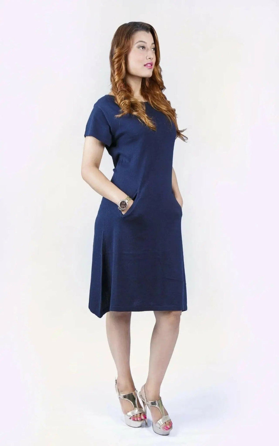 Woman in blue crew neck cashmere dress on white background