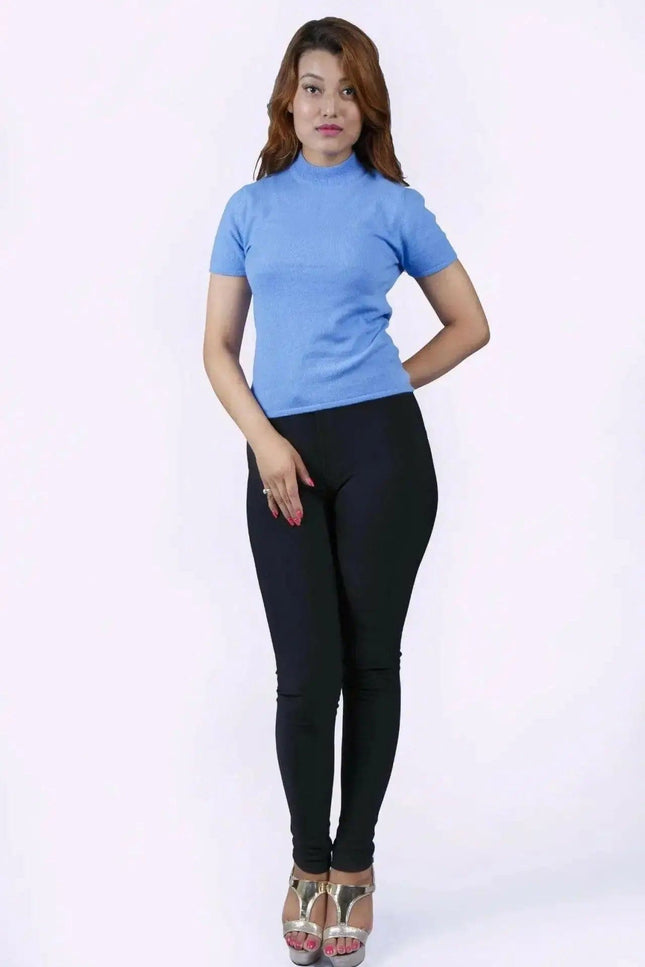 Italian Cashmere Short Sleeve Mock Neck with flattering turtle neck in smart cable pattern worn by woman in blue top and black pants
