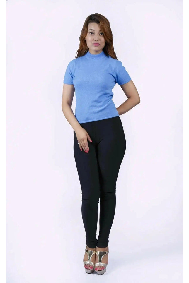 Italian Cashmere Short Sleeve Mock Neck with flattering turtle neck in smart cable pattern worn by woman in blue top and black pants