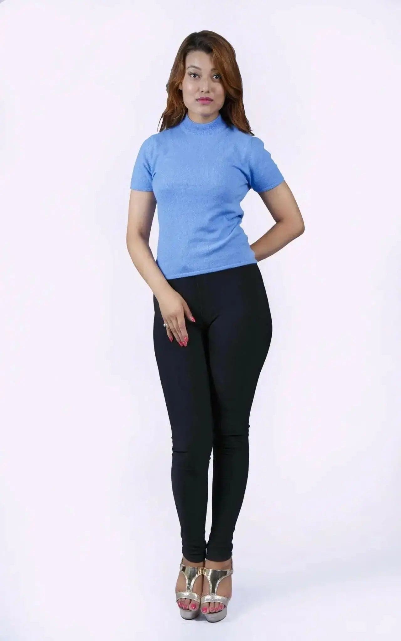 Italian Cashmere Short Sleeve Mock Neck with flattering turtle neck in smart cable pattern worn by woman in blue top and black pants