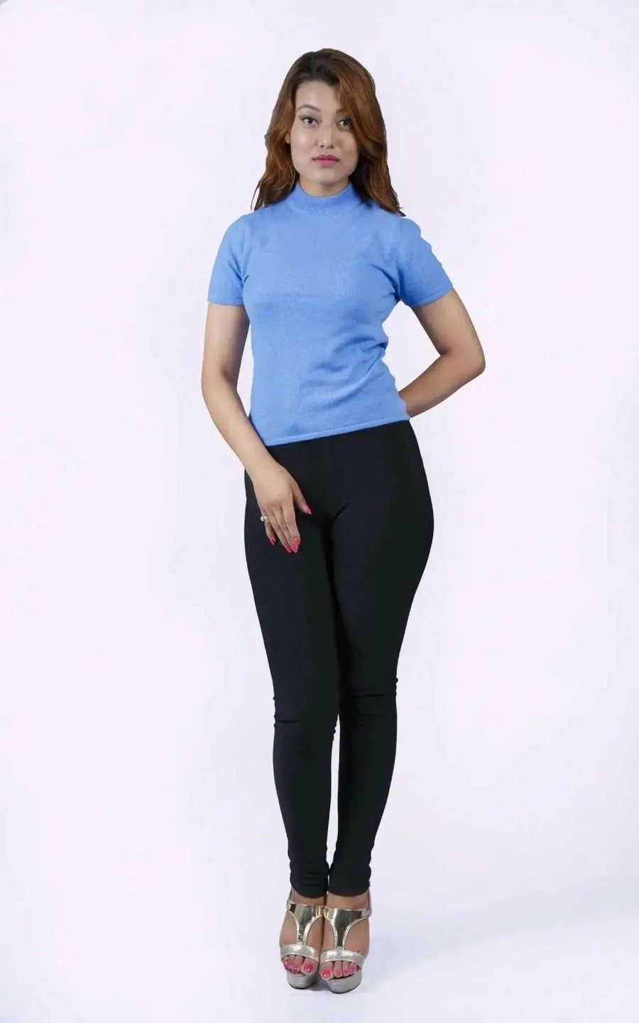 Italian Cashmere Short Sleeve Mock Neck with flattering turtle neck in smart cable pattern worn by woman in blue top and black pants
