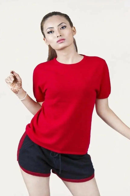Woman in red shirt and black shorts modeling Italian Cashmere Turtle Neck T-Shirt with flattering turtle neck design