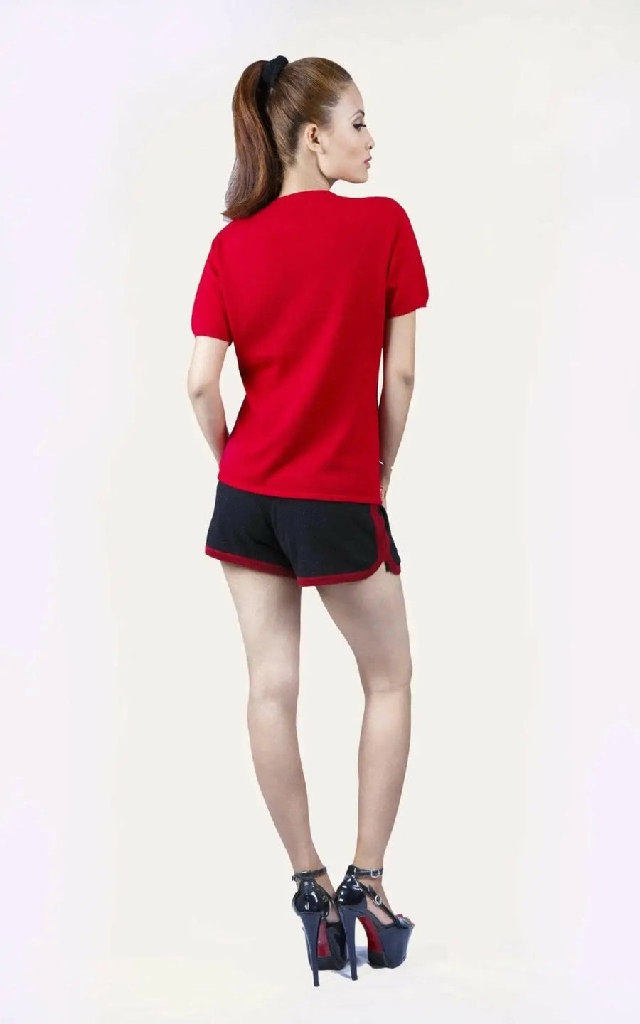 Italian Cashmere Turtle Neck T-Shirt with a flattering turtle neck worn by a woman in red shirt and black shorts
