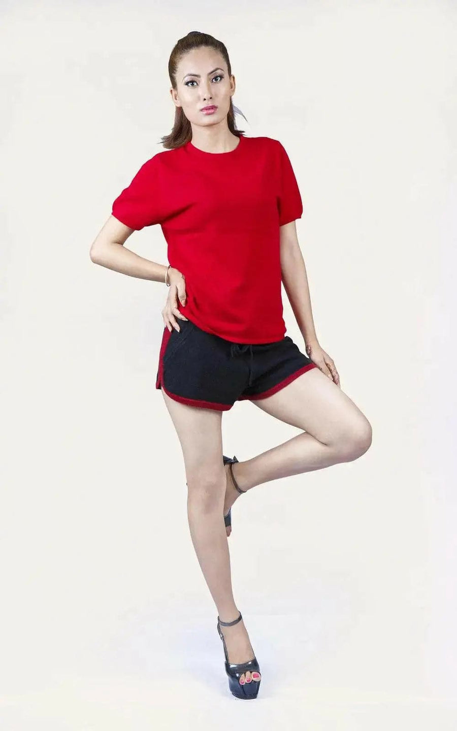 Italian Cashmere Turtle Neck T-Shirt featuring a woman in red shirt and black shorts