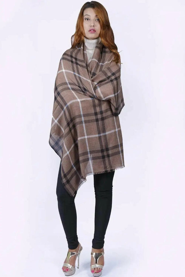 Woman in KCI 182 brown and black plaid poncho with raw trim