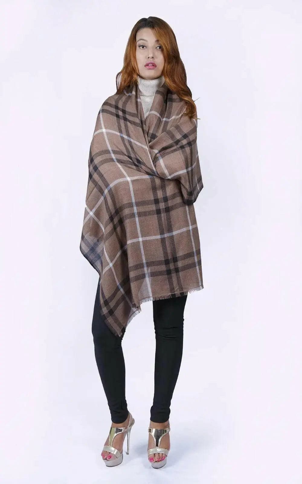 Woman in KCI 182 brown and black plaid poncho with raw trim