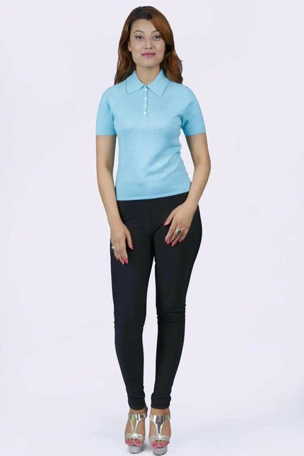 Woman in blue shirt and black pants, teal polo collar, KCI 232