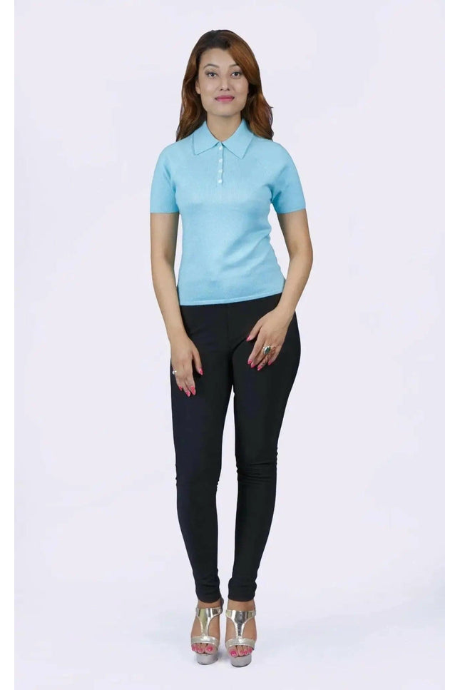 Woman in blue shirt and black pants, teal polo collar, KCI 232