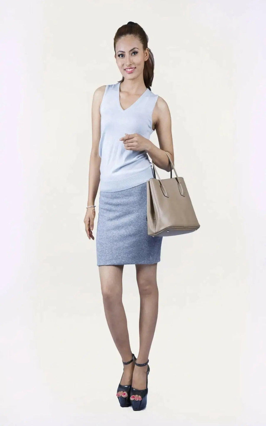Woman in white top and blue skirt wearing KCI 233 cashmere skirt