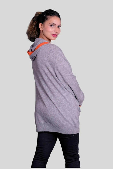 Woman wearing a grey cashmere hooded sweater with orange trim - KCI 293