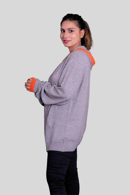 Woman in KCI 293 cashmere hooded sweater with orange trims