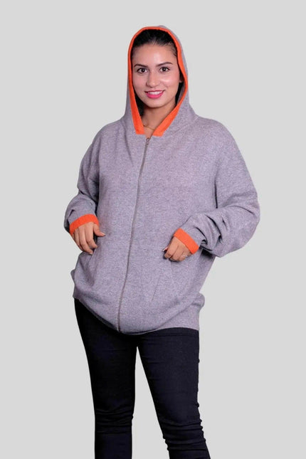 Woman wearing grey and orange cashmere hooded sweater by KCI 293