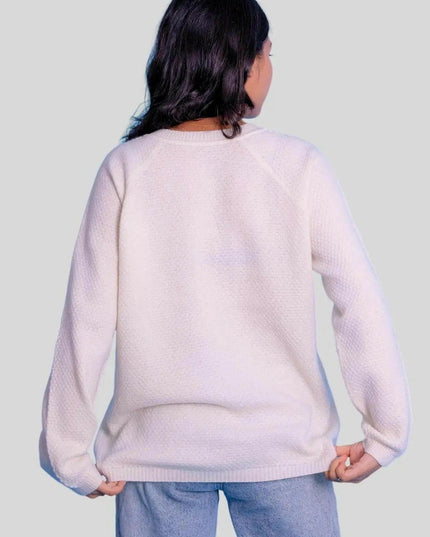 Stylish woman in white crew neck pullover and jeans from KCI 303 collection