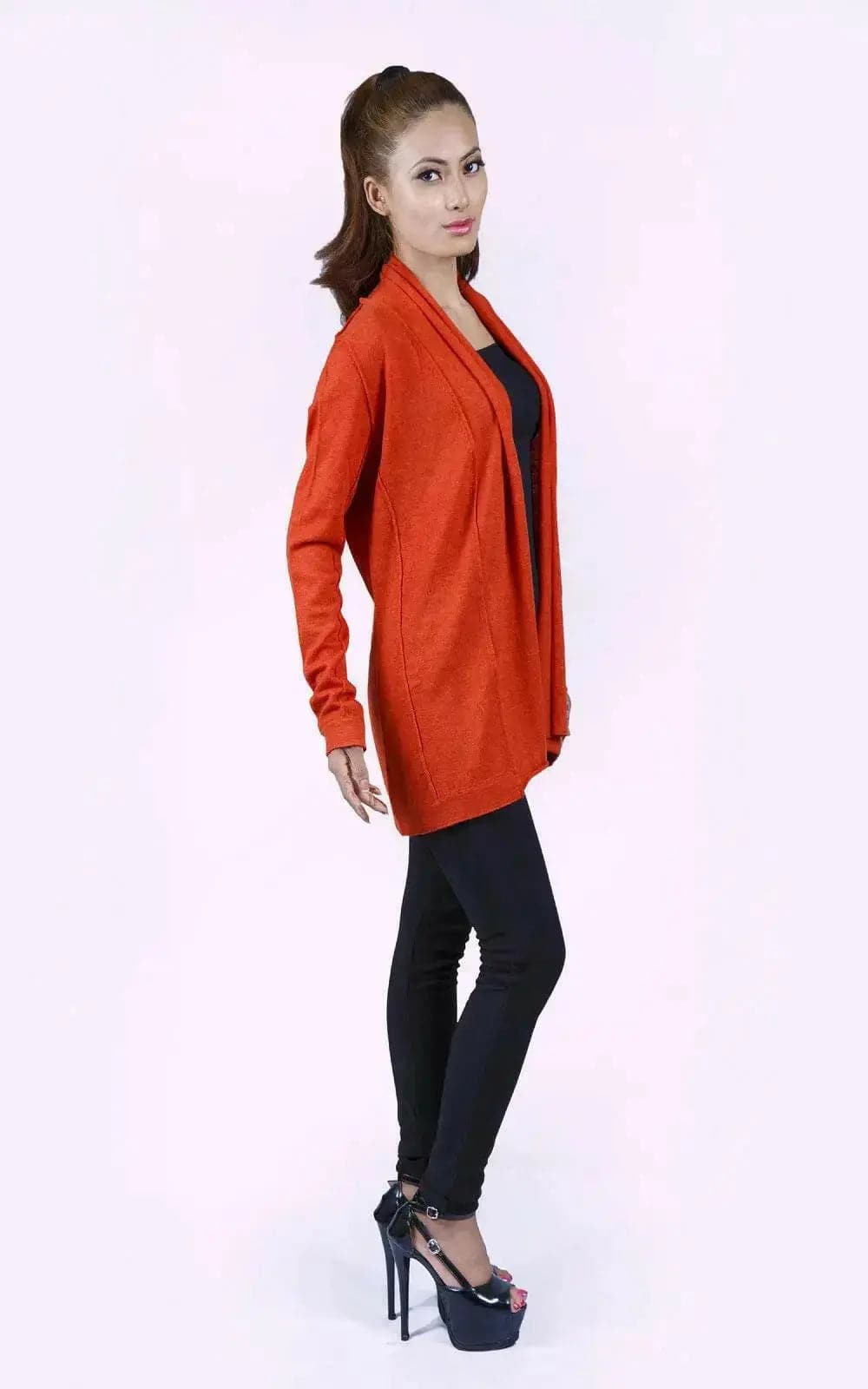 Stylish woman in red jacket and black pants showcasing the Luxurious Ashley Open Knit Cashmere Cardigan