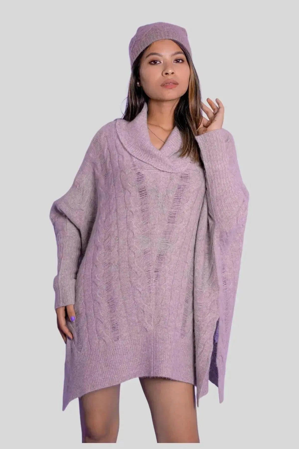 Woman in purple cashmere oversized cable pullover and hat