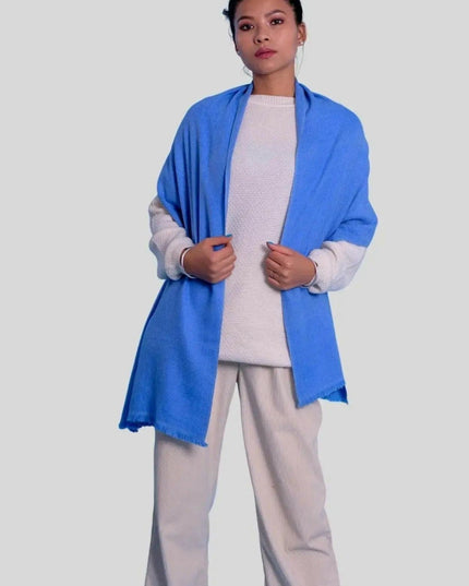 Woman in blue jacket and white pants wearing luxurious cashmere herringbone scarf