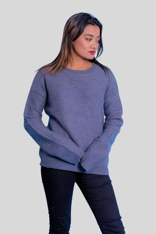 Woman wearing blue cashmere ribbed pullover and black jeans