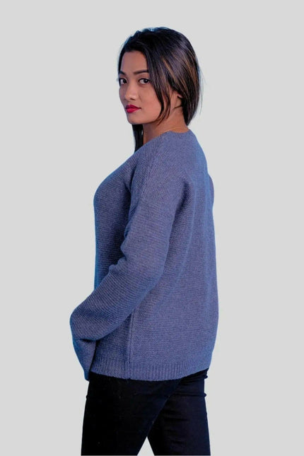 Luxurious cashmere ribbed pullover featuring a woman in blue sweater and black jeans
