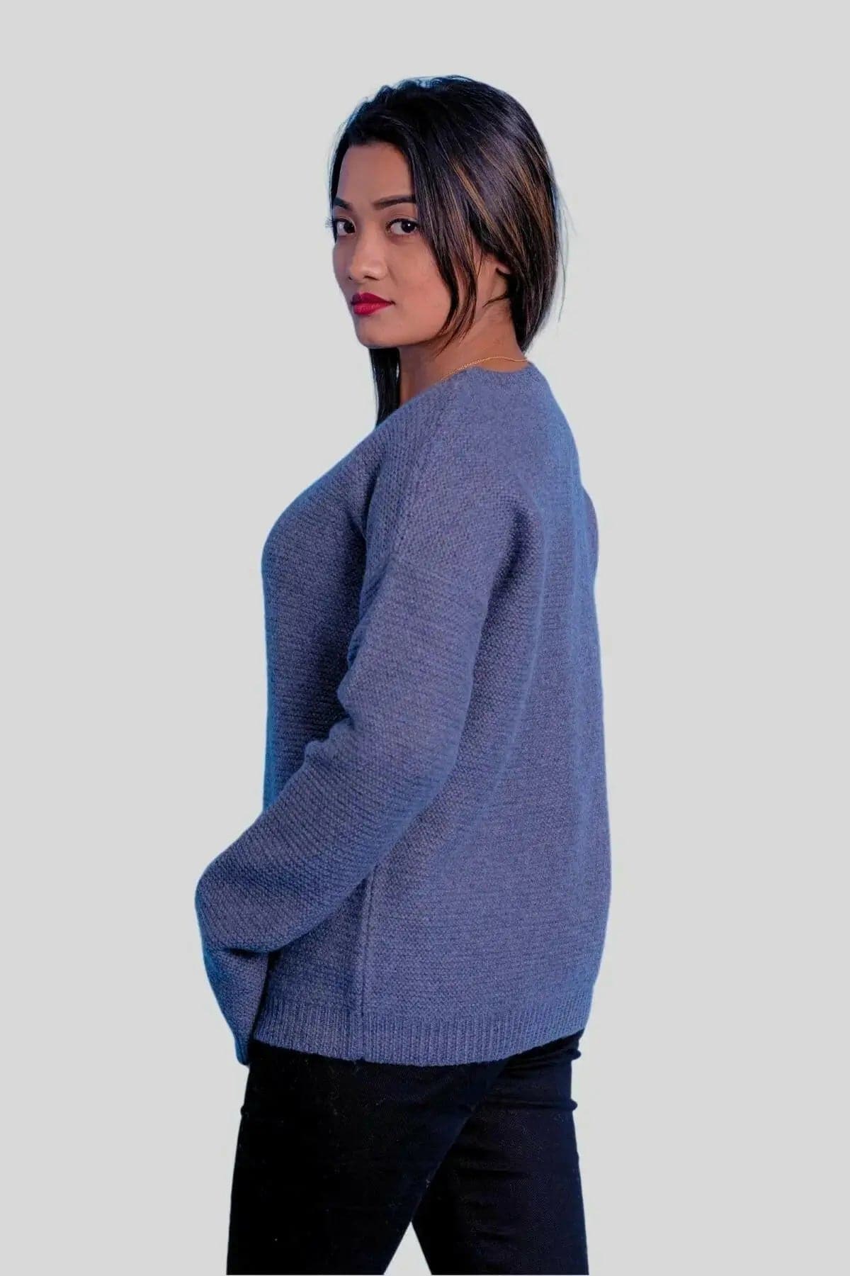 Luxurious cashmere ribbed pullover featuring a woman in blue sweater and black jeans
