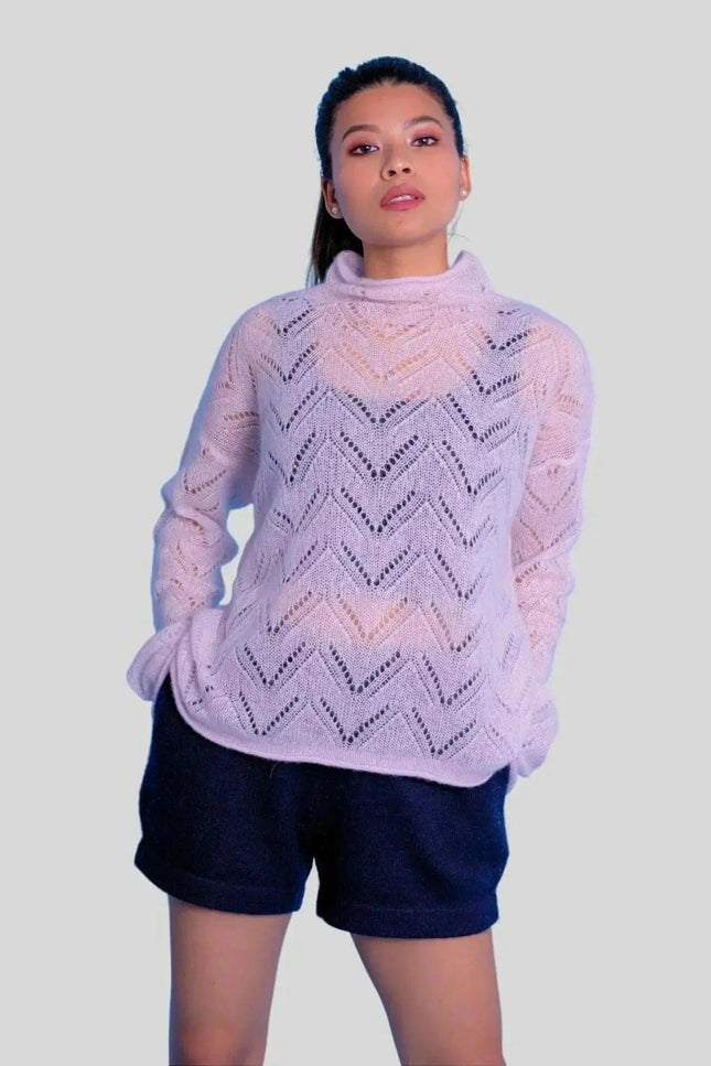 Woman wearing luxurious cashmere silk pointelle pullover in pink