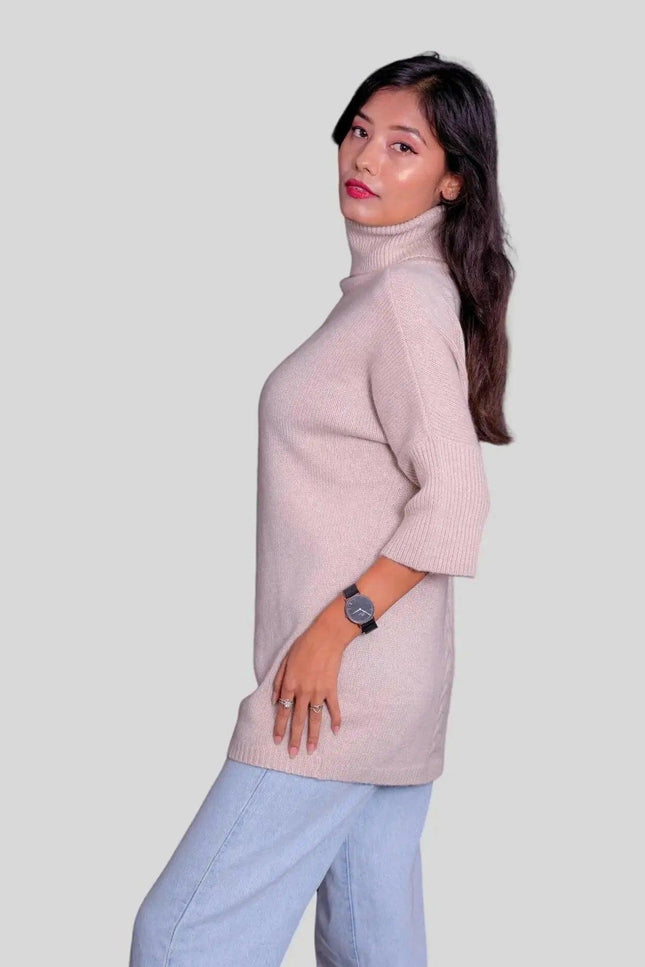 Luxurious cashmere turtleneck pullover modeled by woman in pink sweater