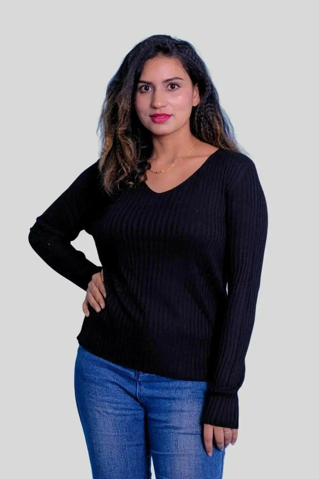 Stylish woman in jeans and black sweater wearing luxurious cashmere v neck pullover