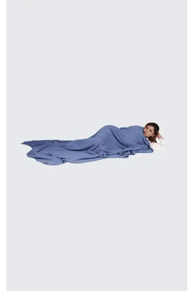 Woman laying on ground with head down, experiencing ultimate luxury with Luxurious Dark Gray Blue Cashmere Blanket