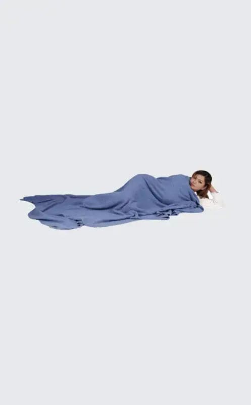 Woman laying on ground with head down, experiencing ultimate luxury with Luxurious Dark Gray Blue Cashmere Blanket