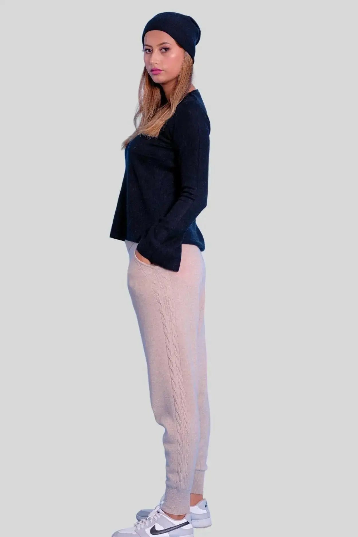 Luxurious Italian Cashmere Cable Trouser featuring woman in black sweater and beige pants