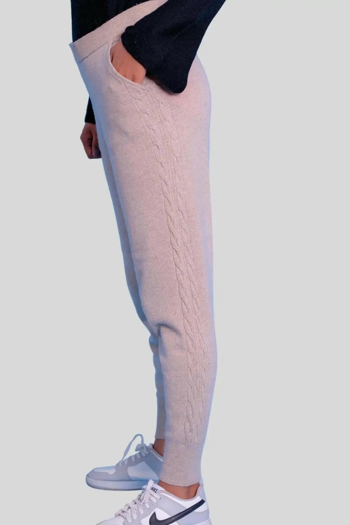 Stylish woman in black sweater and white sneakers wearing Luxurious Italian Cashmere Cable Trouser